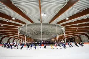 Het marathonpeloton raast door de bocht in de Elfstedenhal in Leeuwarden